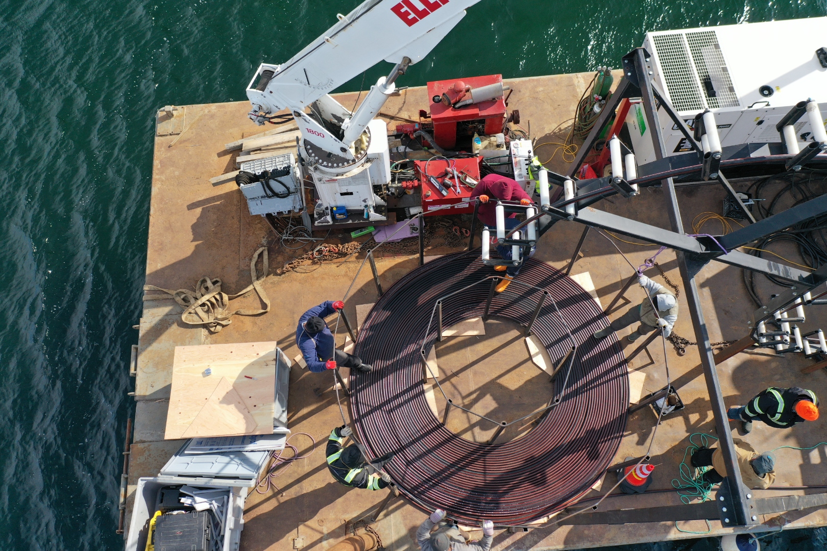 Overhead view of submarine cable coiled on barge deck