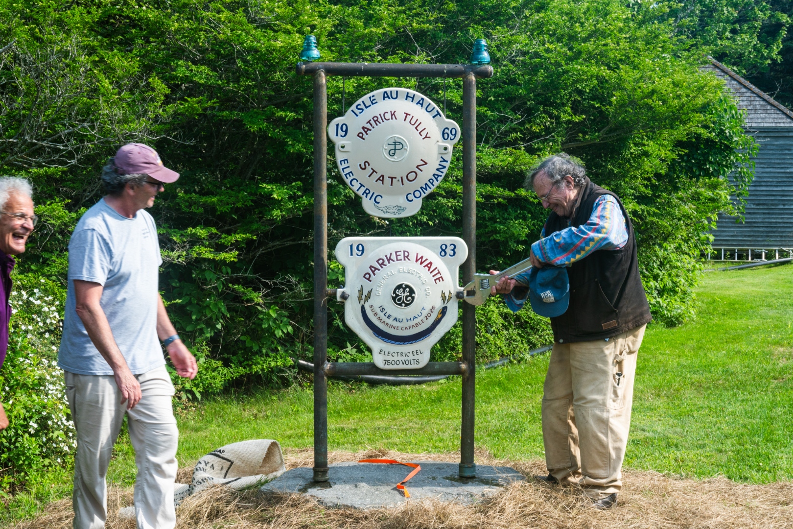 Parker Waite tightening the commemorative plaque in his honor in 2026 for 43 years of uninterrupted undersea cable service