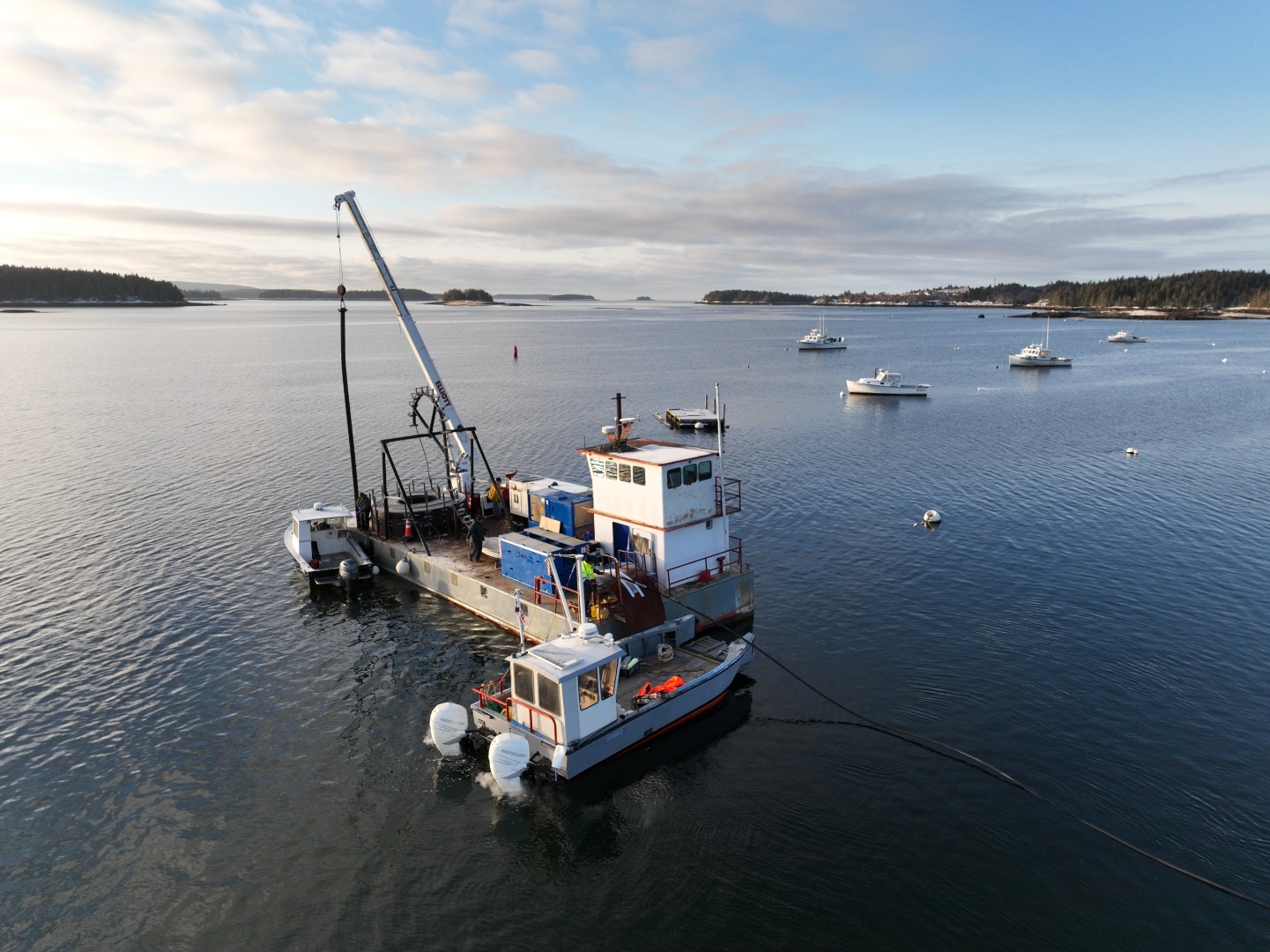 Pulling the cable through its protective conduit before the run across the bay in February