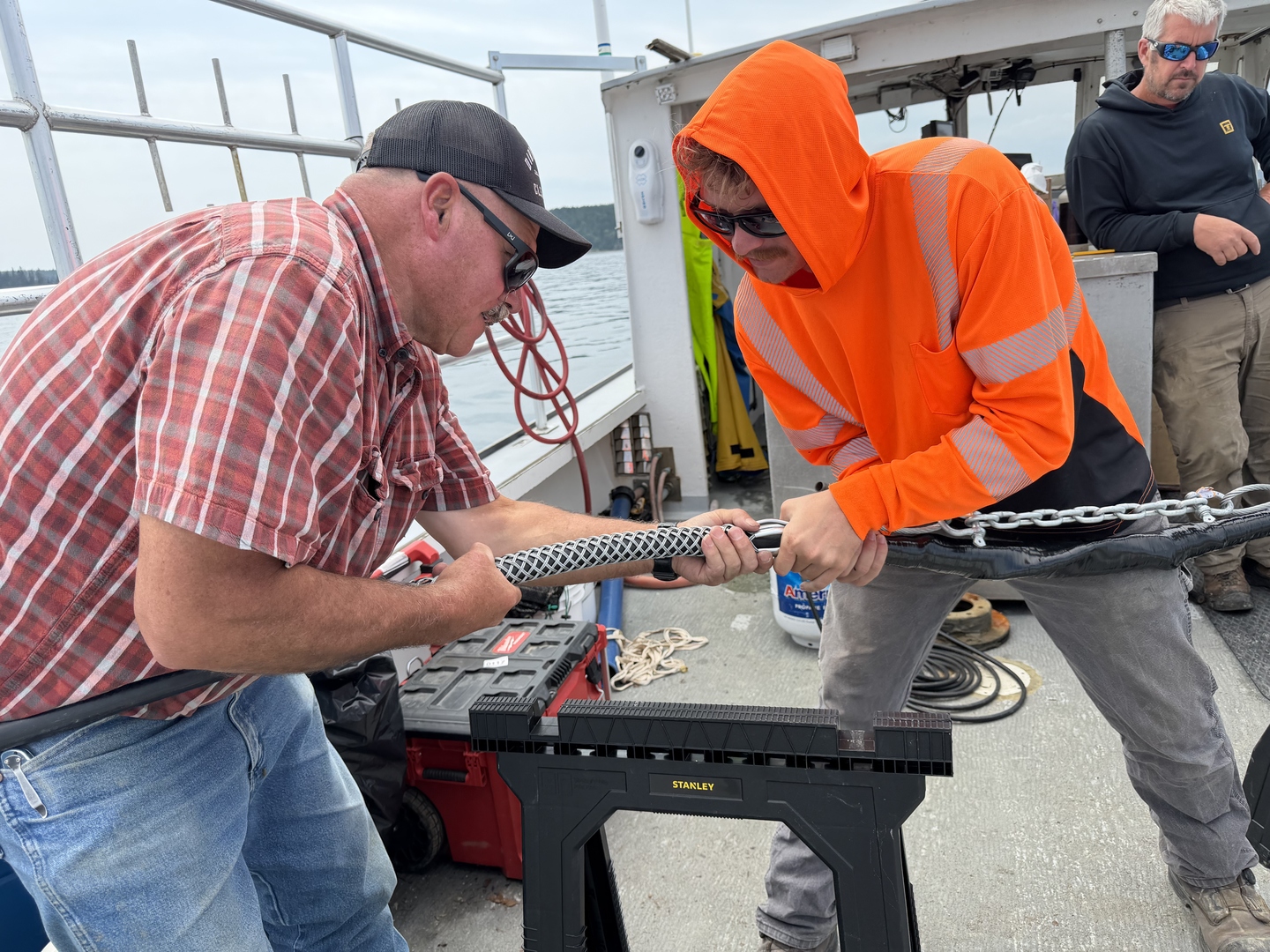 Splicers add tension protection on the final splice connecting the island to the mainland in July