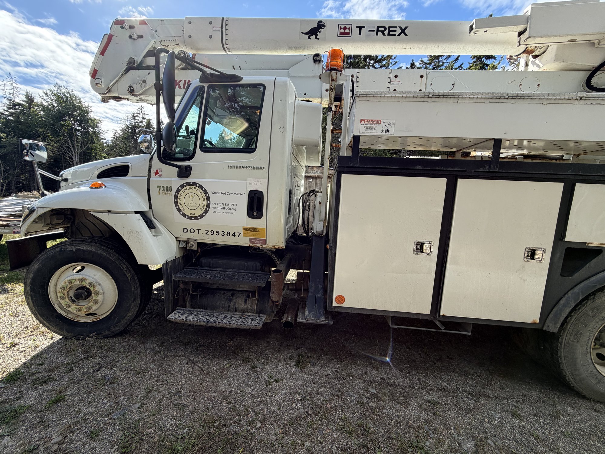 Our new bucket truck, second-life on the island, with T-Rex branding