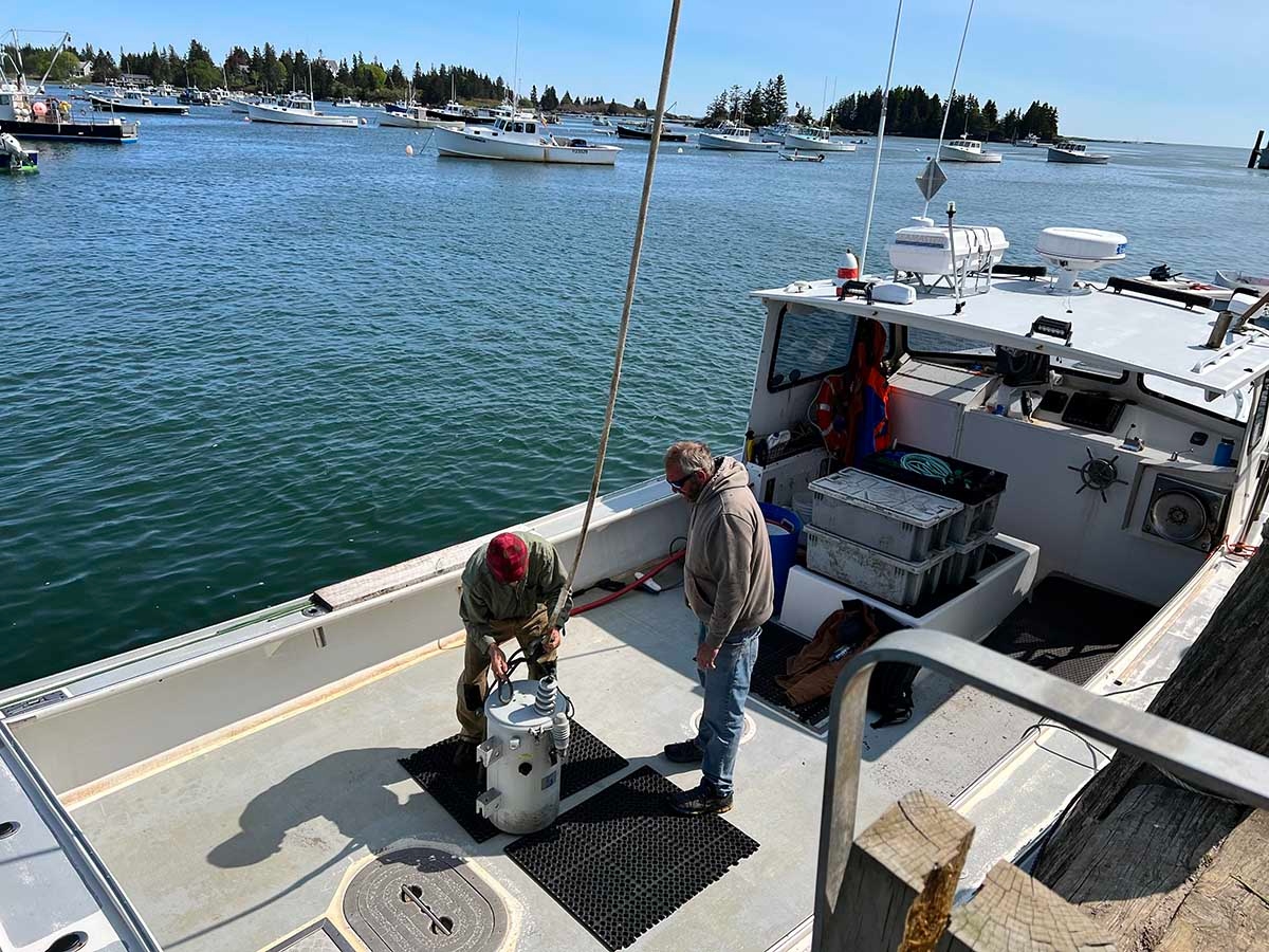Transformer donated by Fox Island Power Co-op being unloaded from a lobster boat